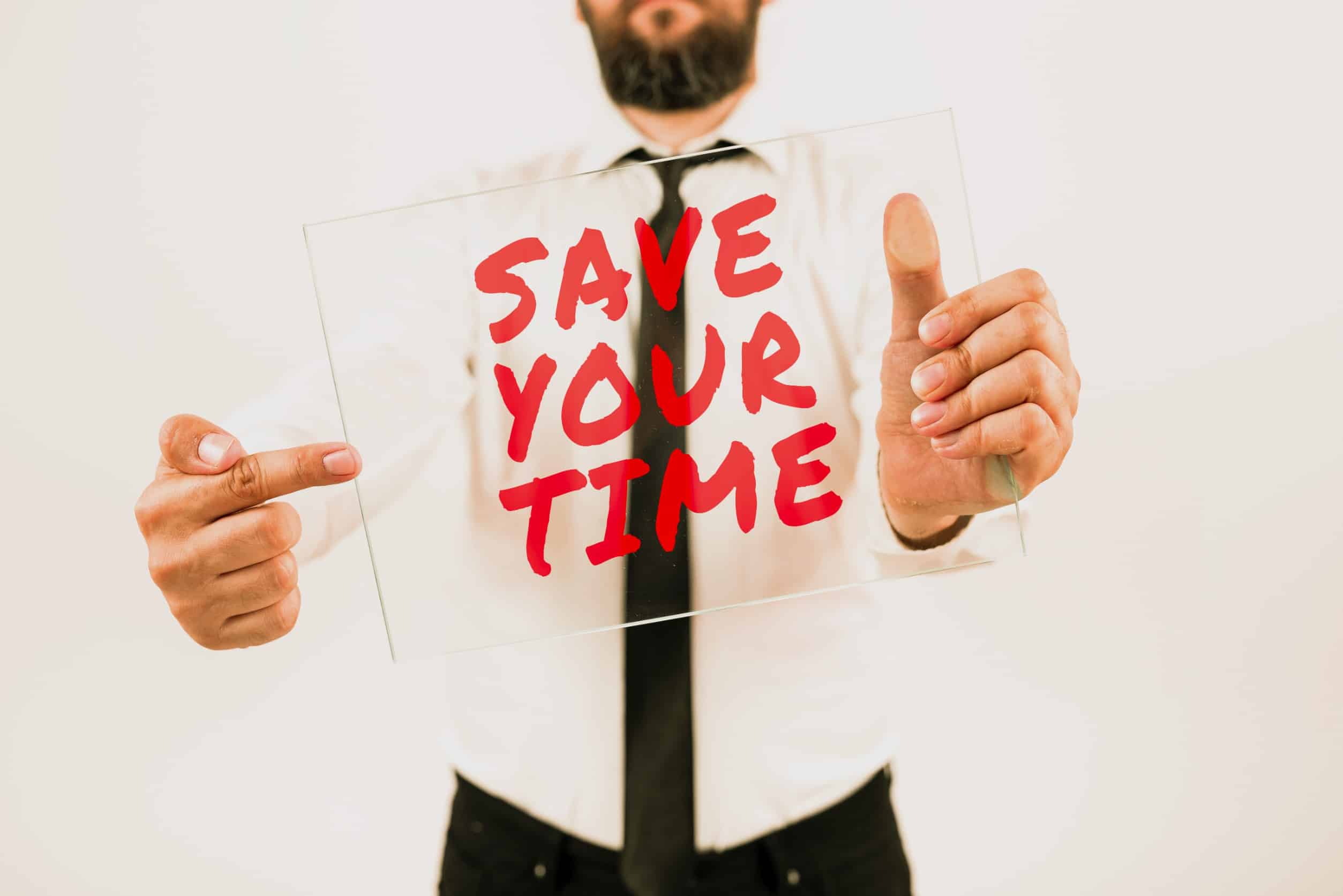 Man holding sign that reads save your time.