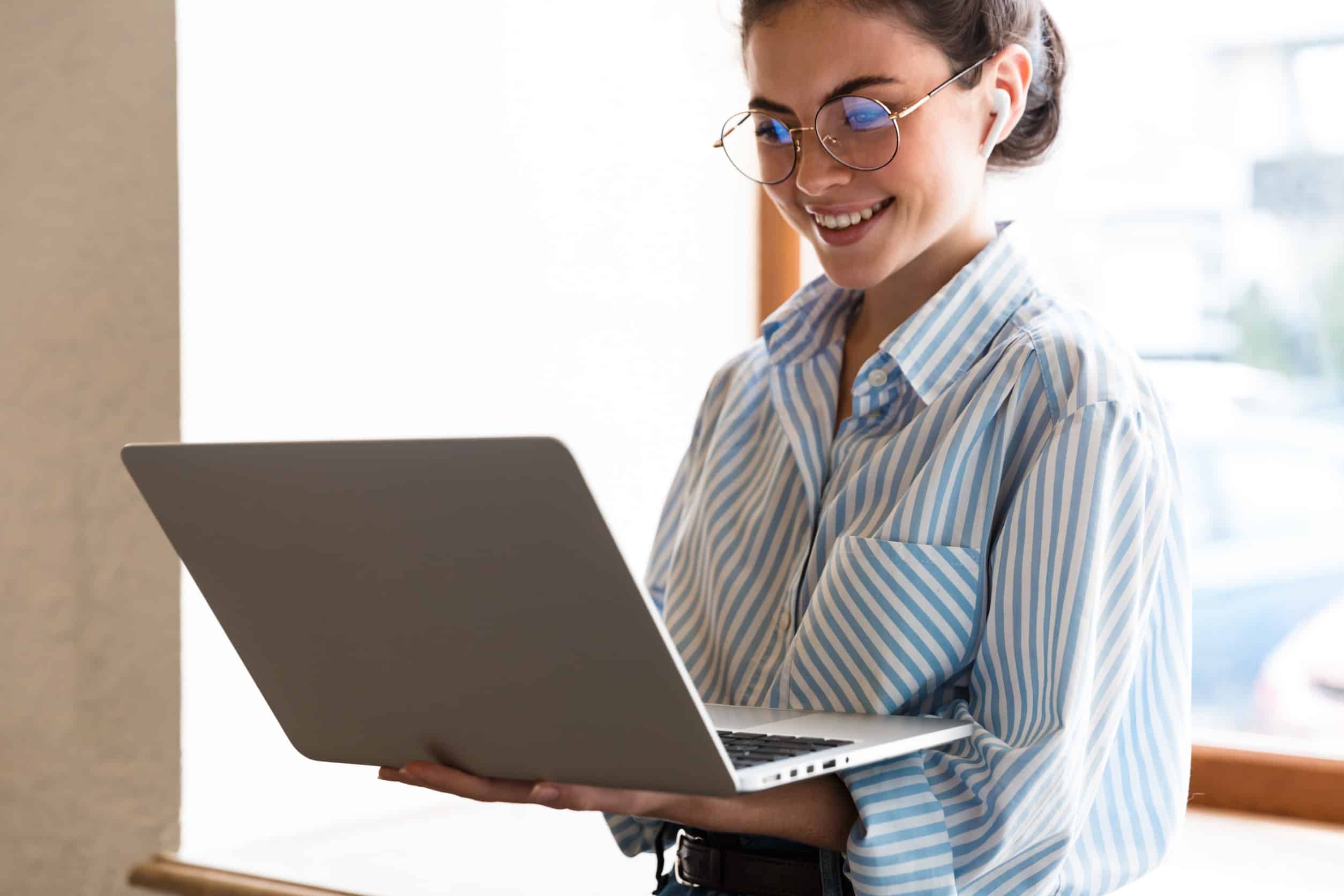 woman smiling working on computer happy with the results from her messaging framework